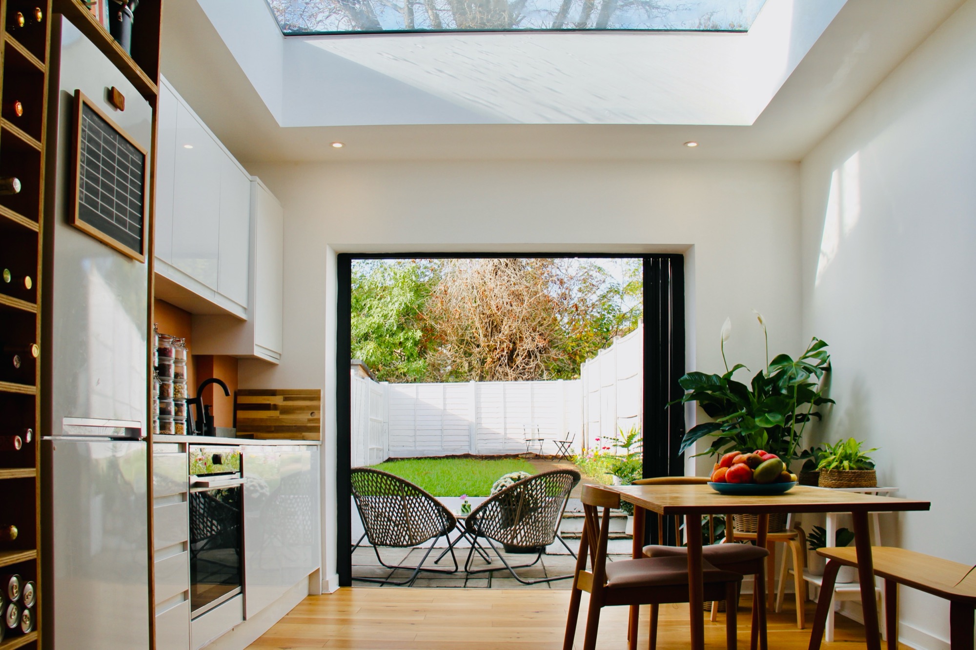 Kitchen extension with glazed roof lantern and folding doors onto the garden