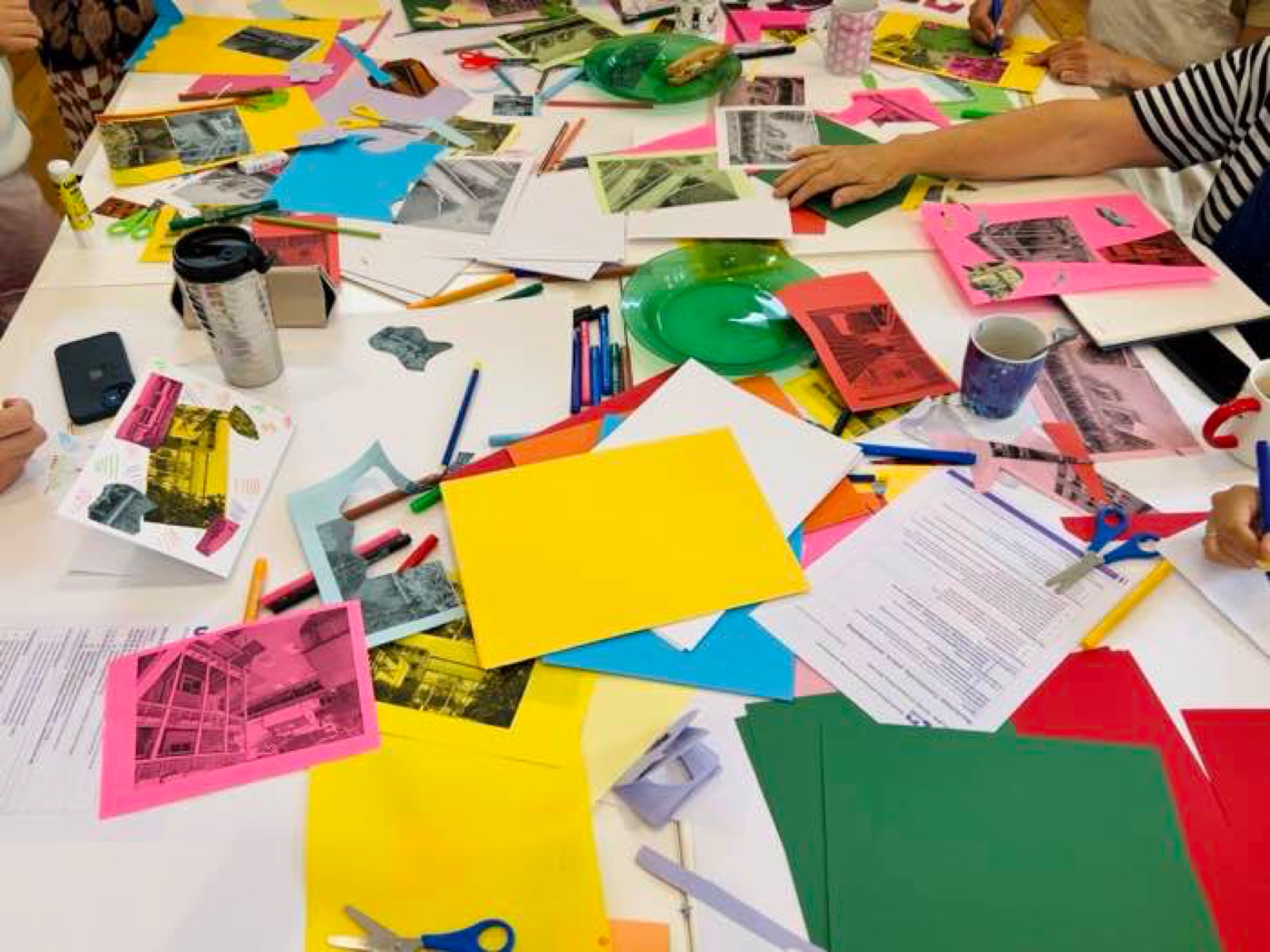 Workshop table with collage materials, alternate view