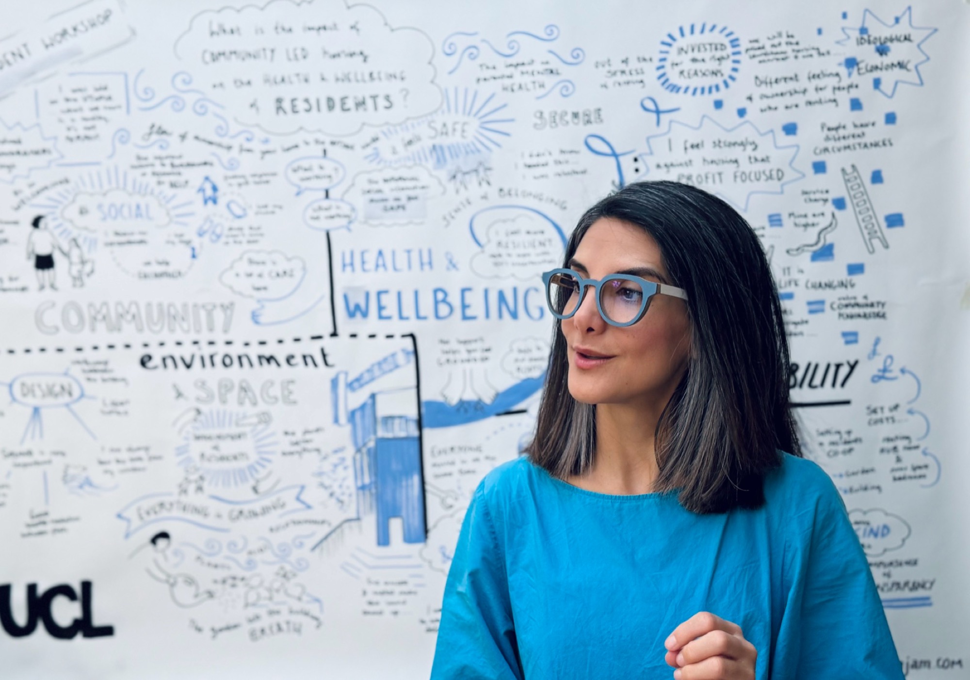 Sahar Nava presenting in front of the live illustration board