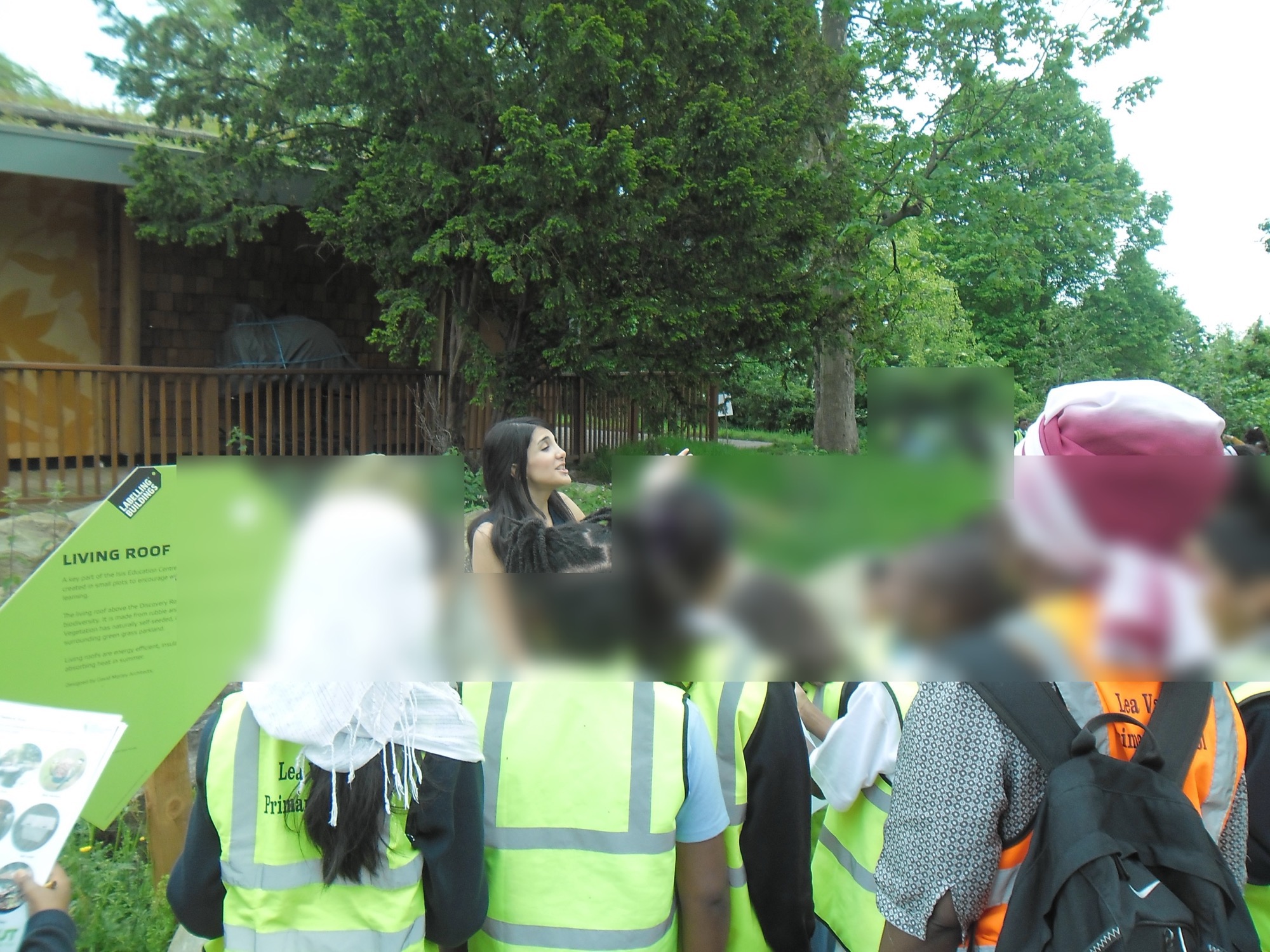 Working with primary school children on an outdoor architecture activity, faces blurred for privacy